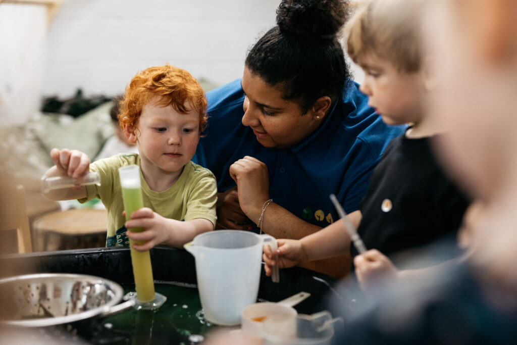 A member of staff playing with a child.