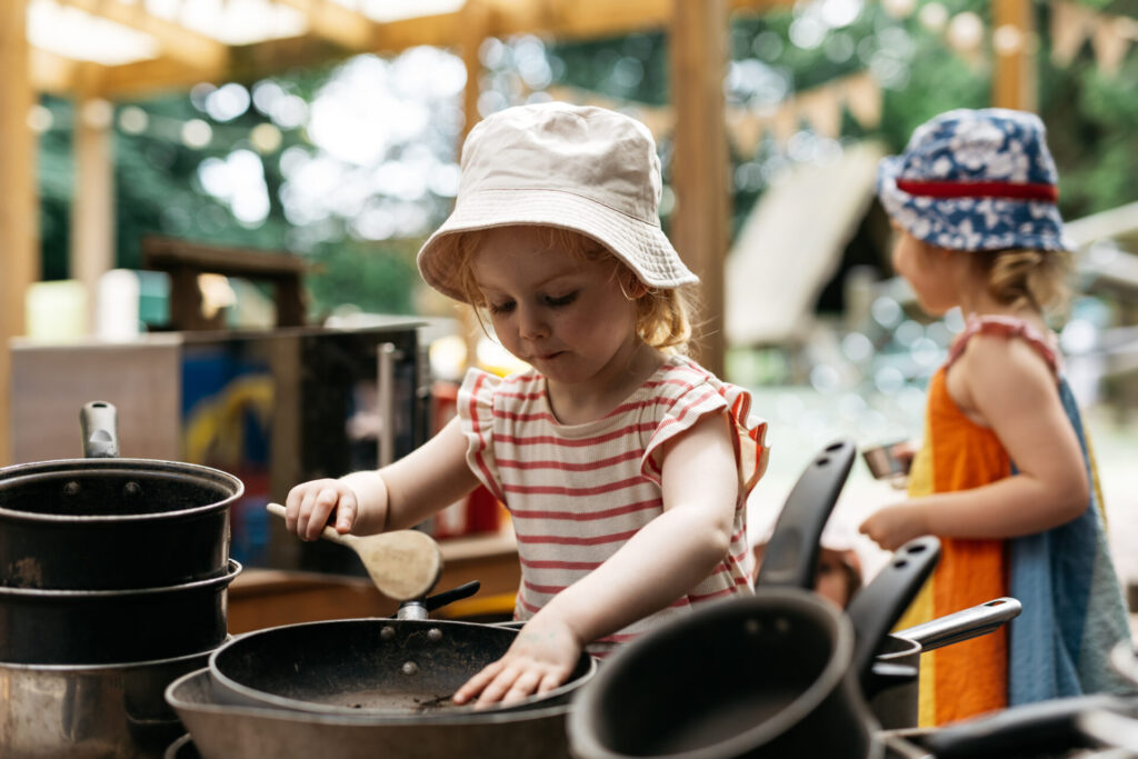 A child playing with cooking pans.
