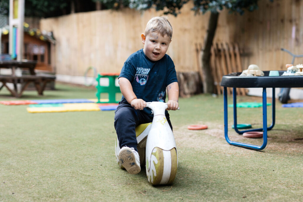 A child on a toy bike