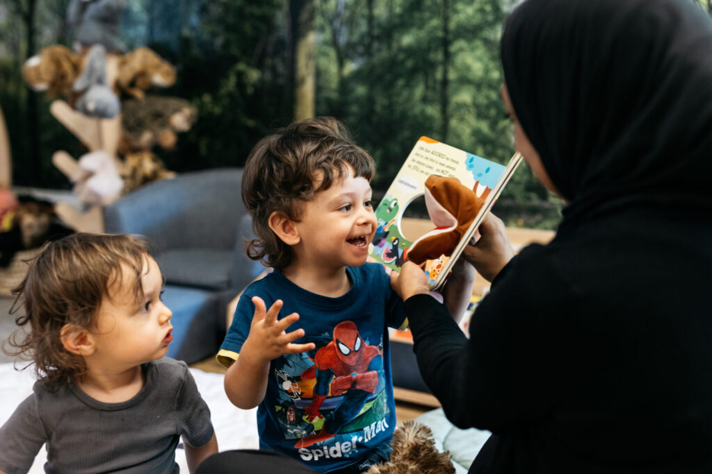 A staff member reading children a book
